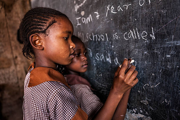 African little girls during their English class in orphanage. There is no light and electricity inside the classroom. Around 50-60 orphans live in this orphanage which is located near Nairobi.